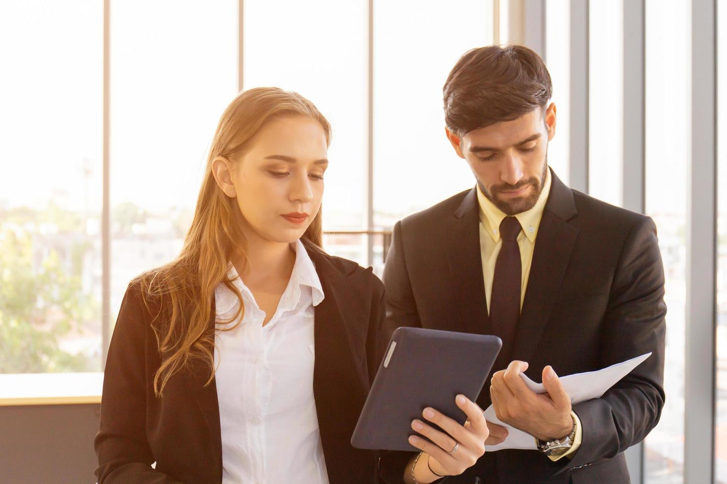 Two business men and women standing meeting in the office photo