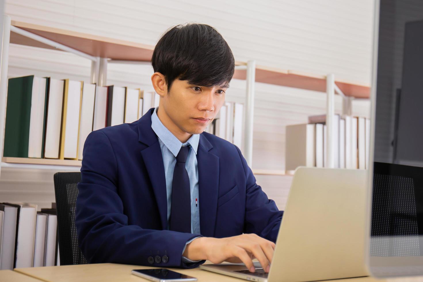 A business man sitting in an office with diligence and determination photo