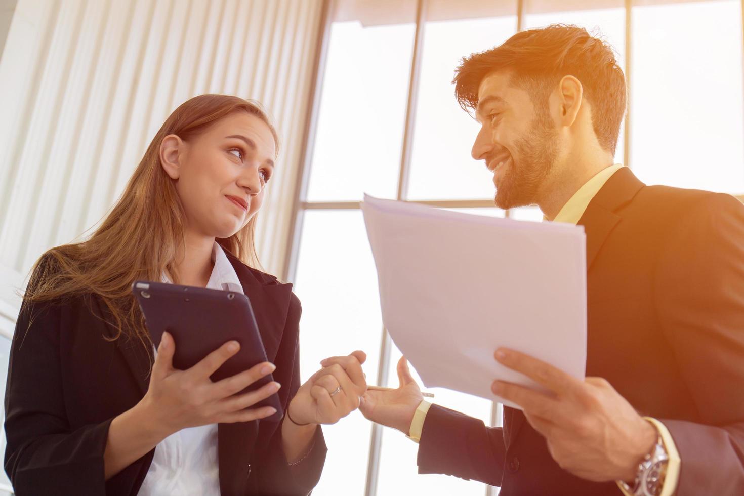 Two business men and women standing meeting in the office photo