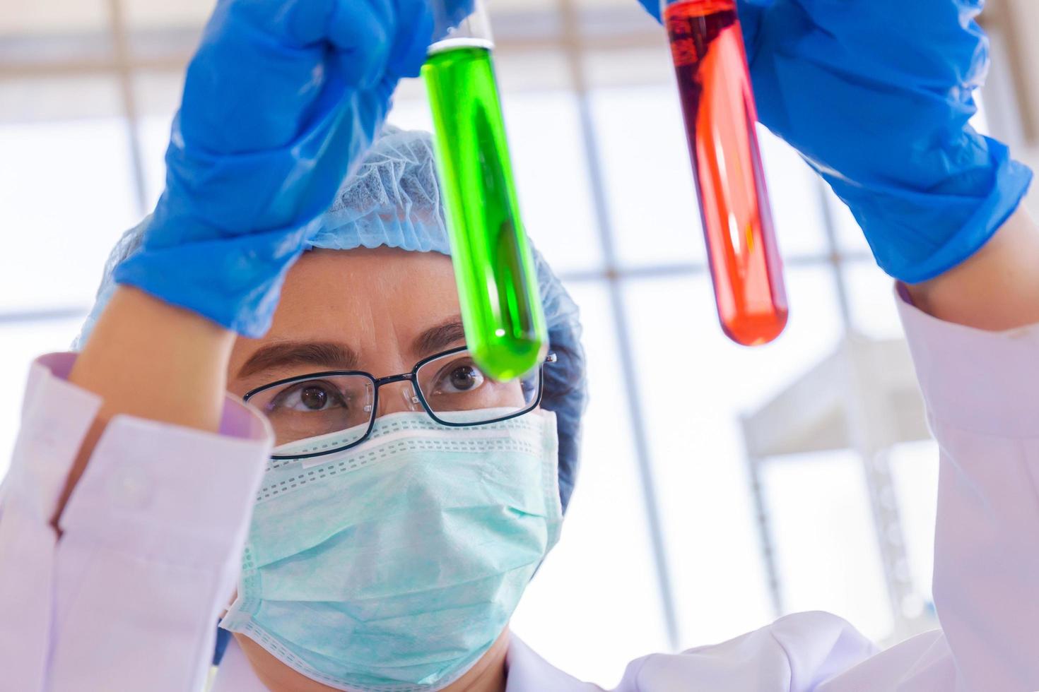 An Asian female scientist is researching a chemical formula in a lab. photo