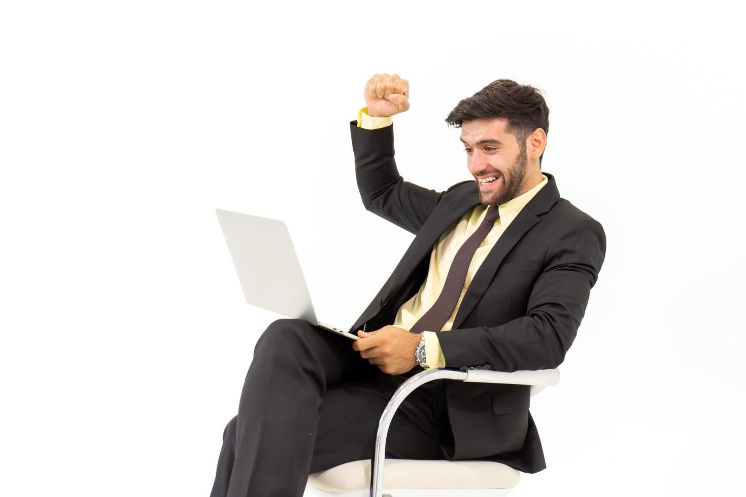 A handsome businessman sitting on a chair showing signs of happiness, isolated on white background, photo