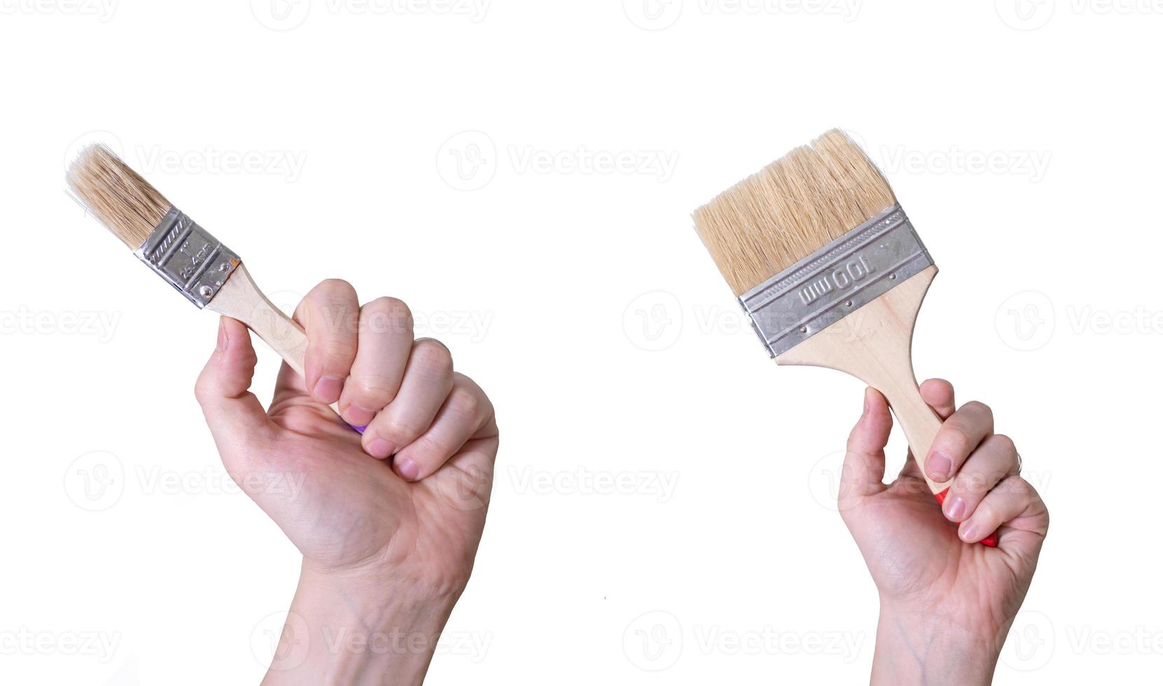 Hands with paint brushes on a white background. Labor Day Concept. photo