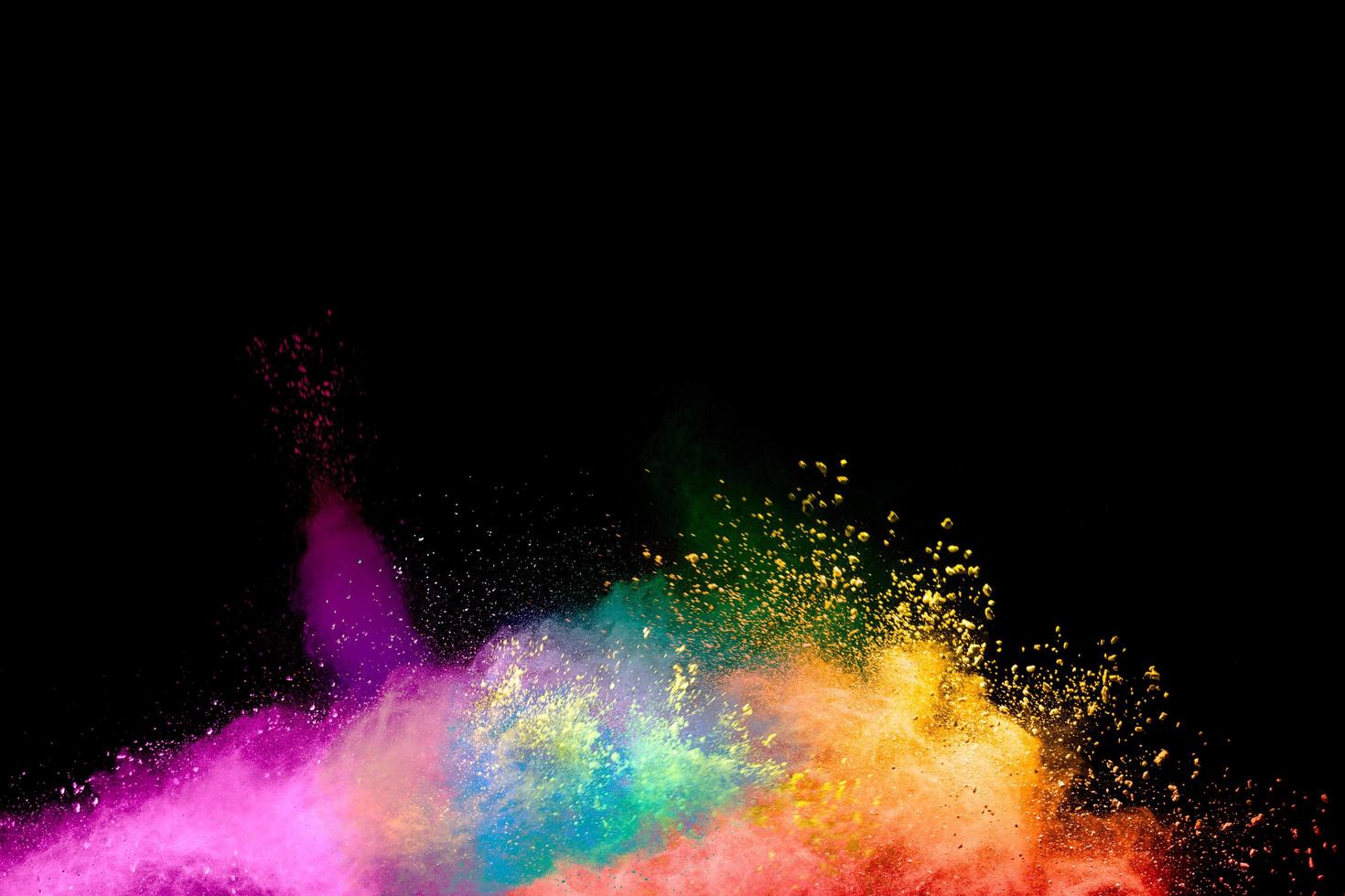 Abstract colorful powder explosion on black background.Freeze motion of dust splash.Painted Holi. photo