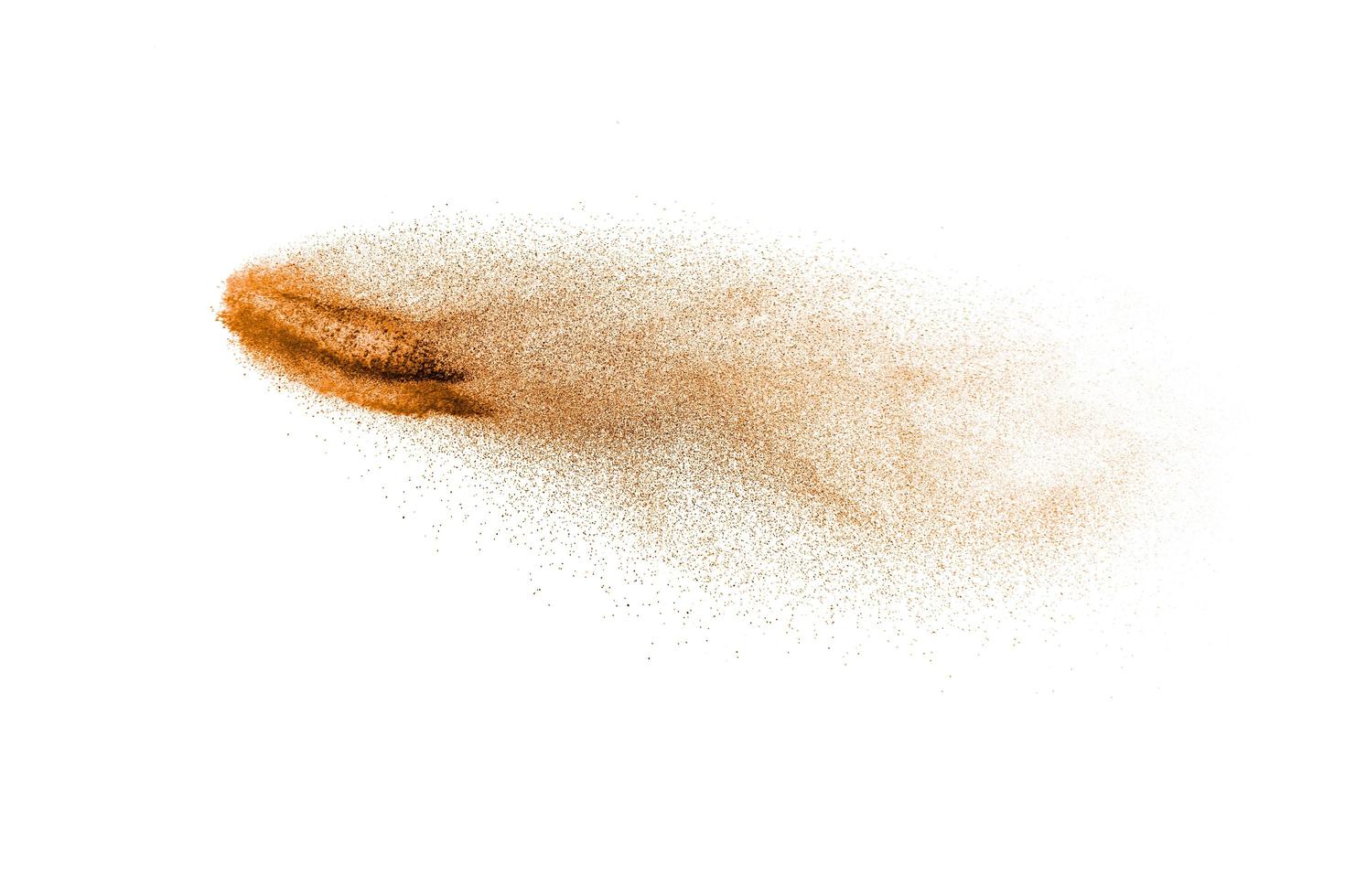 Brown dry river sand explosion isolated on white background. Abstract sand splashing. photo