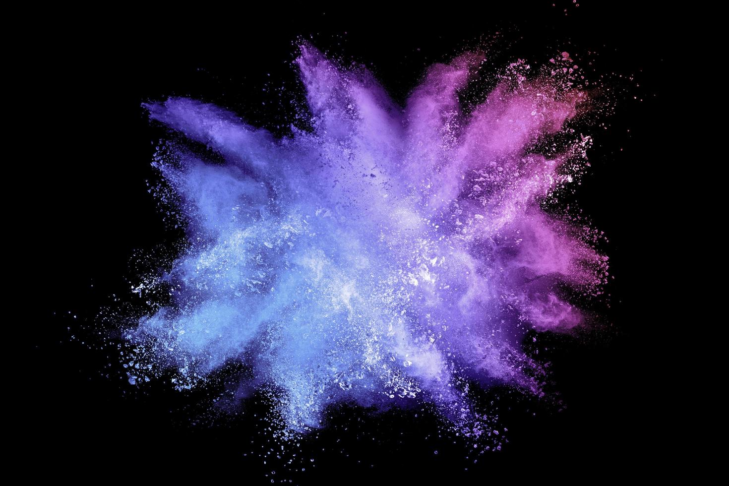 Colorful background of pastel powder explosion.Multi colored dust splash on black background.Painted Holi. photo