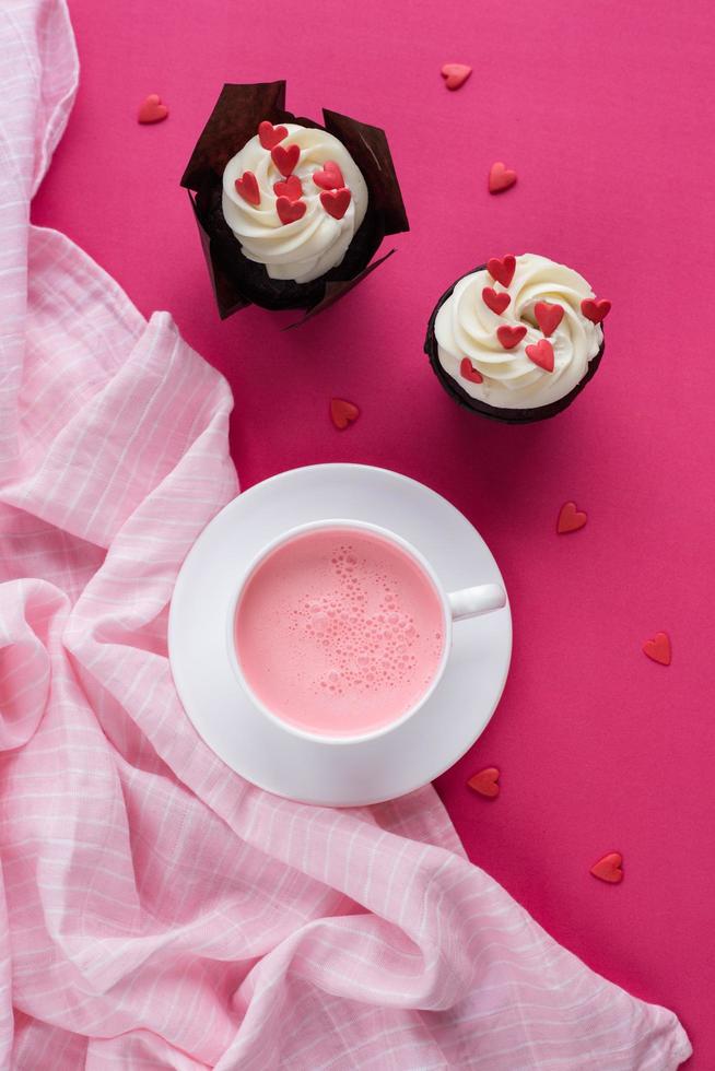 Red velvet cupcakes for Valentines Day in bright pink setting photo