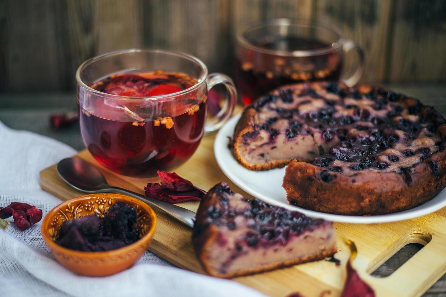 Imperfect blueberry pie. A cozy home-made tea party. Wooden background and white linen. photo