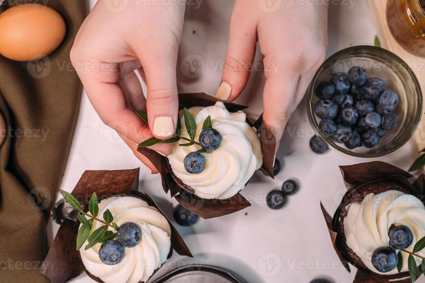 process making homemade chocolate cupcake with cream photo
