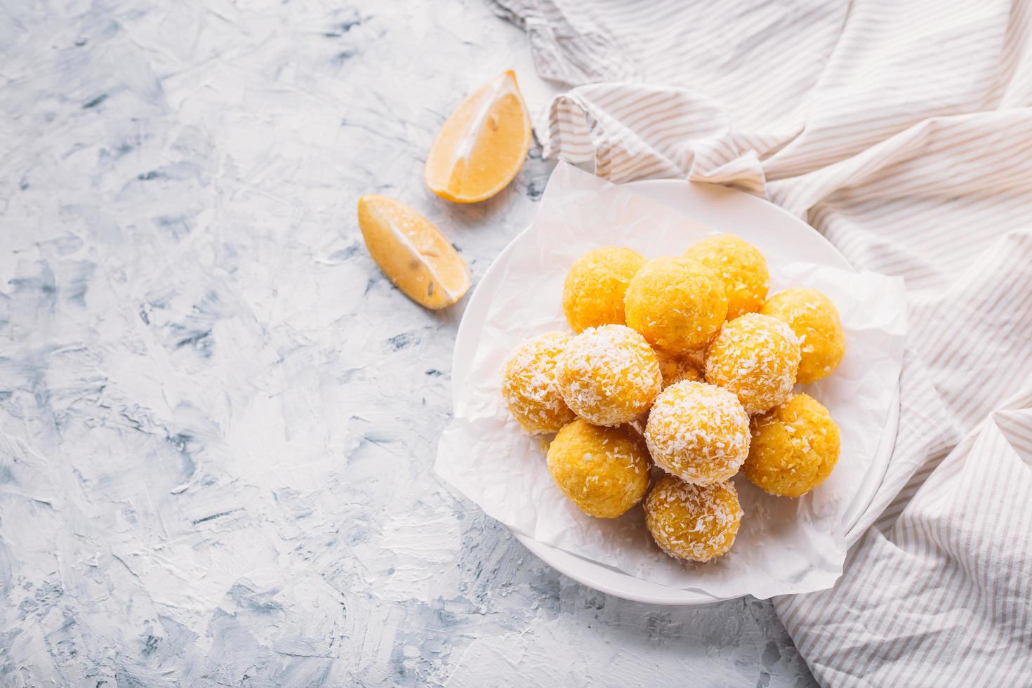 Lemon energy raw balls with coconut flakes photo