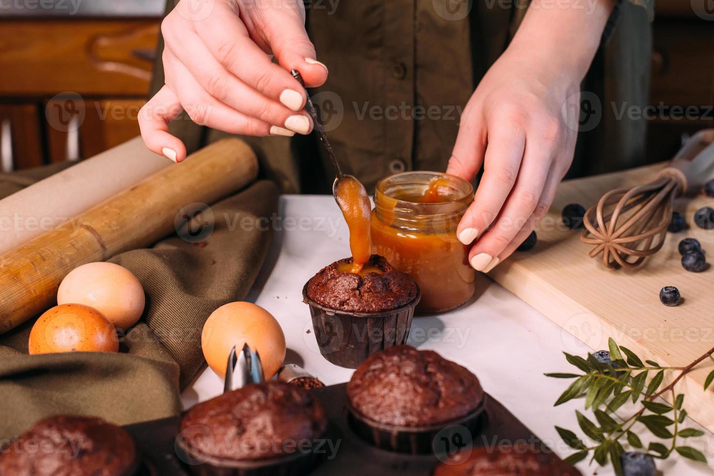 process making homemade chocolate cupcake with cream photo