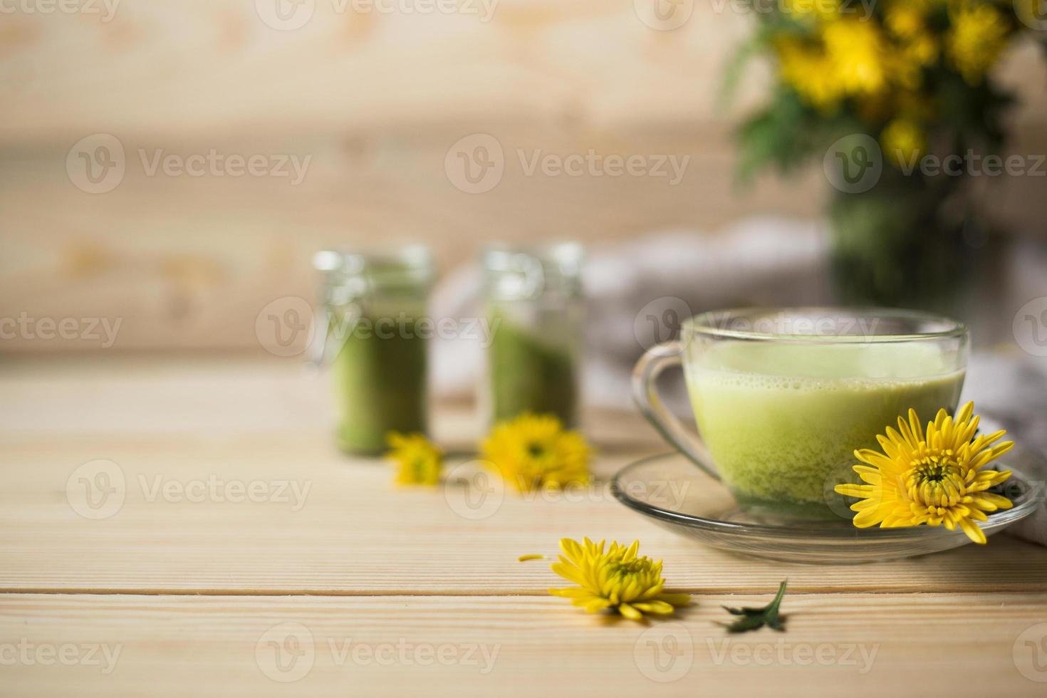 Matcha latte in a cup with matcha powder photo