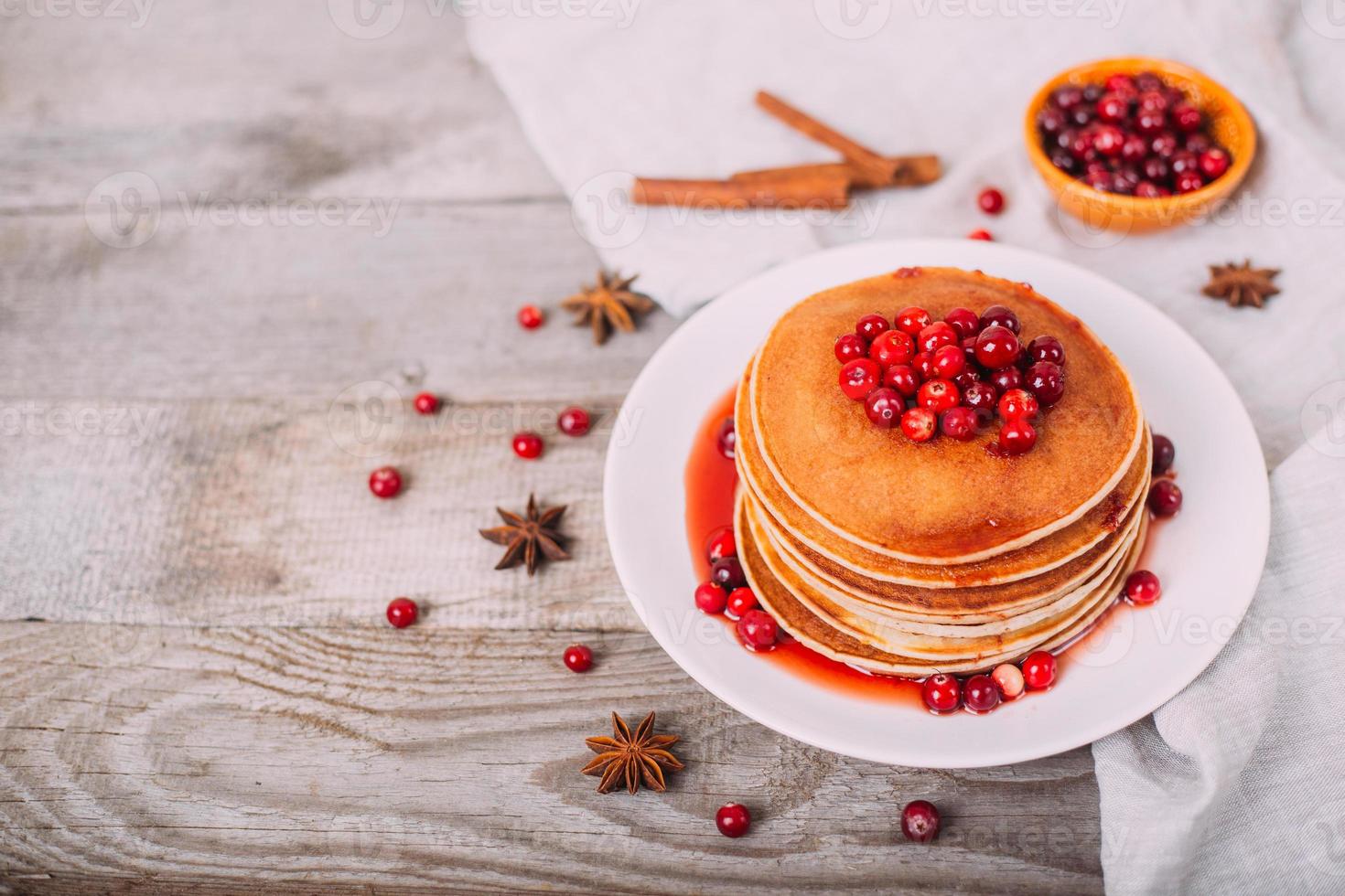 Tasty and bright pancakes with cranberries. photo