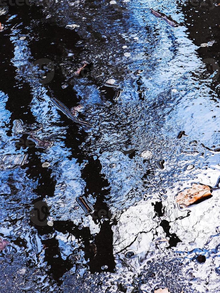 Abstract wet surface in blue with reflections. Blue wet background. photo