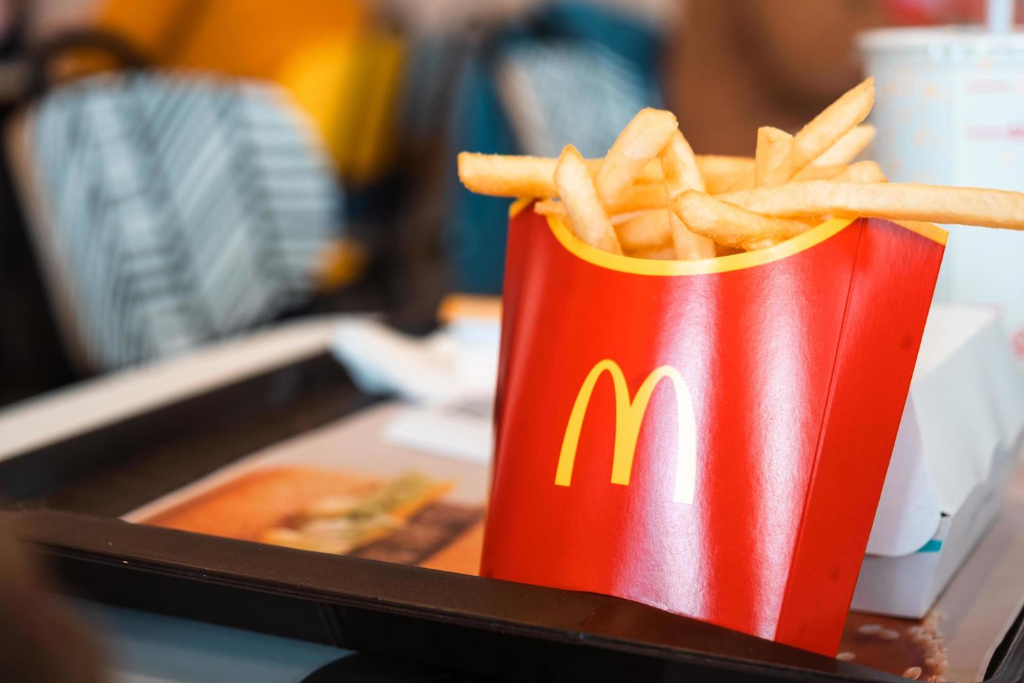 French fries with a red box with the McDonald's logo on a tray and a drink. Fast food restaurant chains. Russia, Kaluga, March 21, 2022. photo