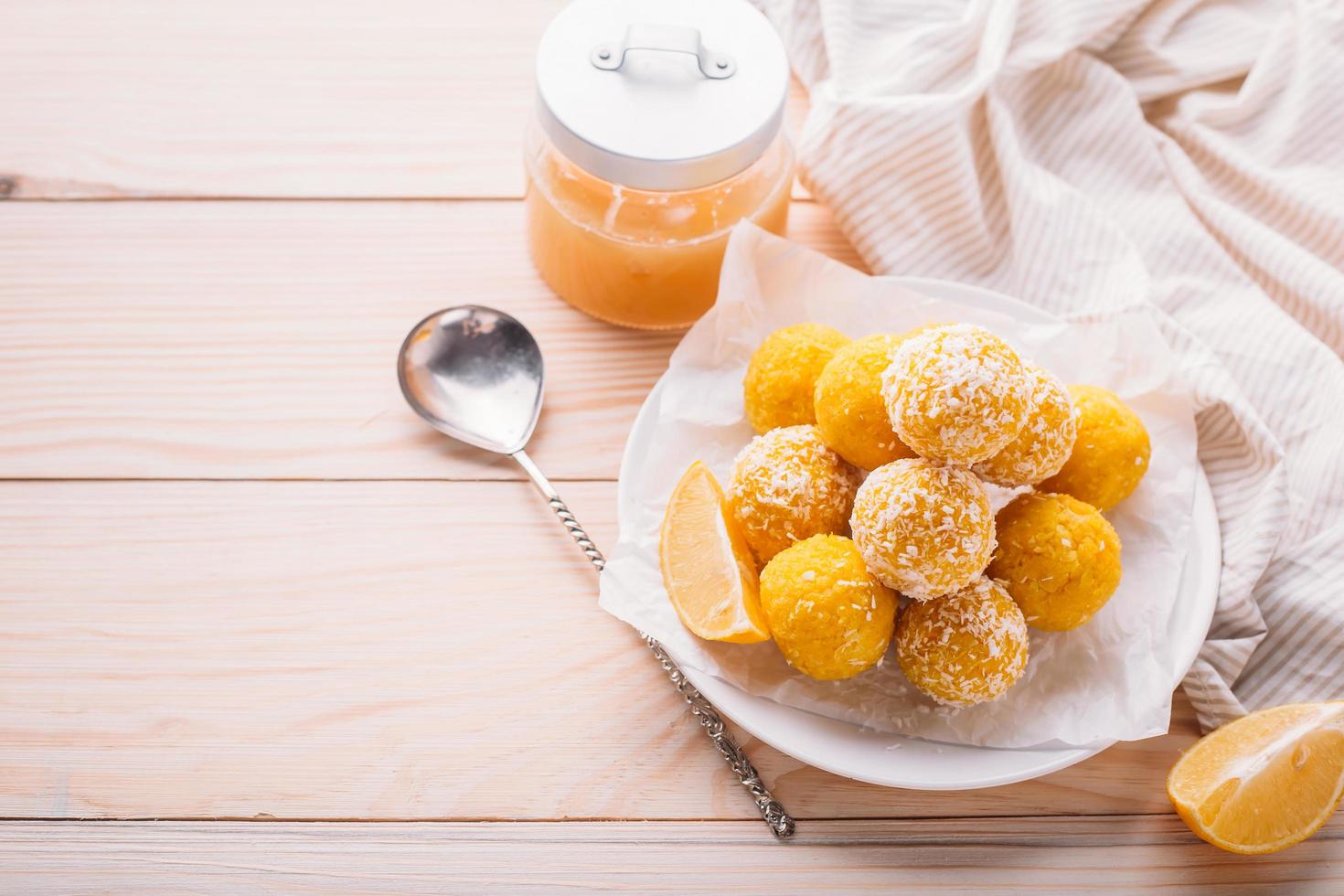 Lemon energy raw balls with coconut flakes photo
