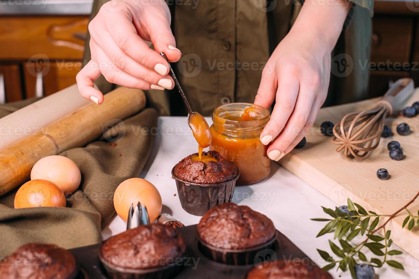 process making homemade chocolate cupcake with cream photo