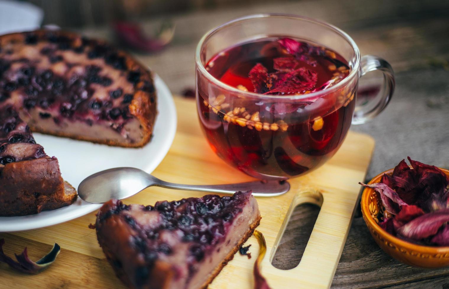 Imperfect blueberry pie. A cozy home-made tea party. Wooden background and white linen. photo