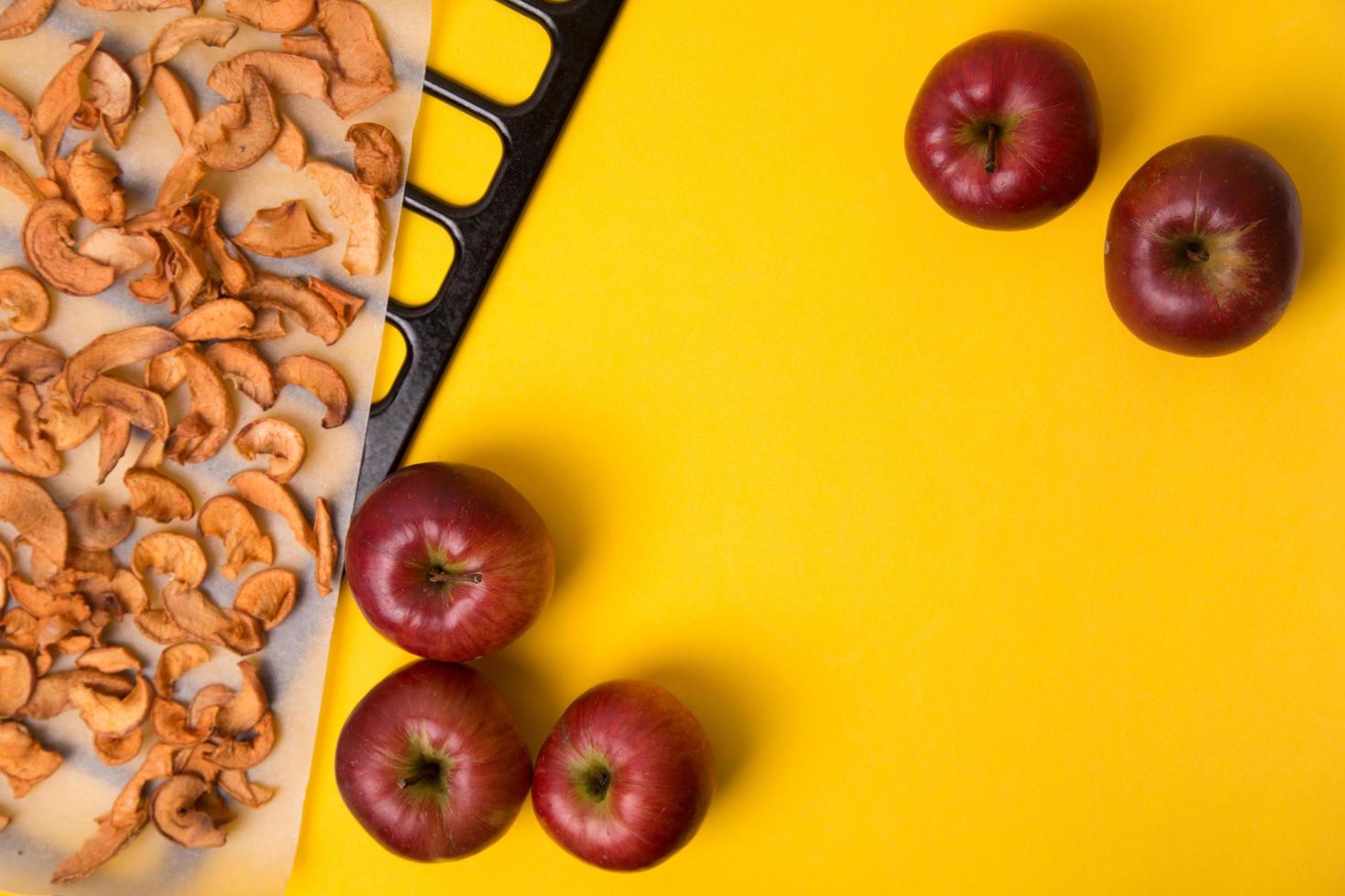 Homemade dried organic apple sliced on yellow background. photo