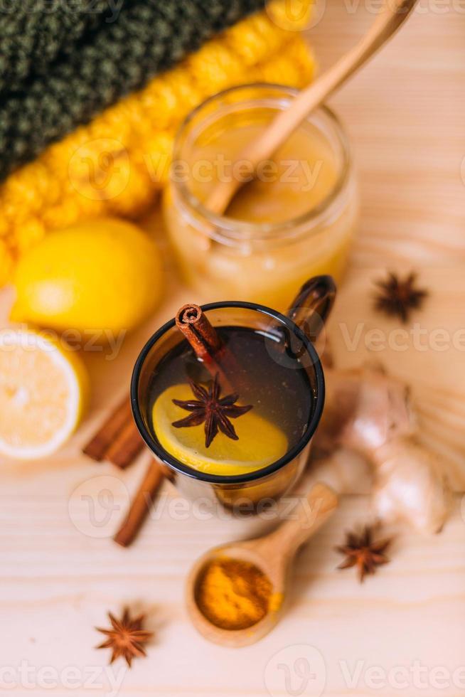 Cup warm water with lemon, honey, ginger root, cinnamon and anise. photo
