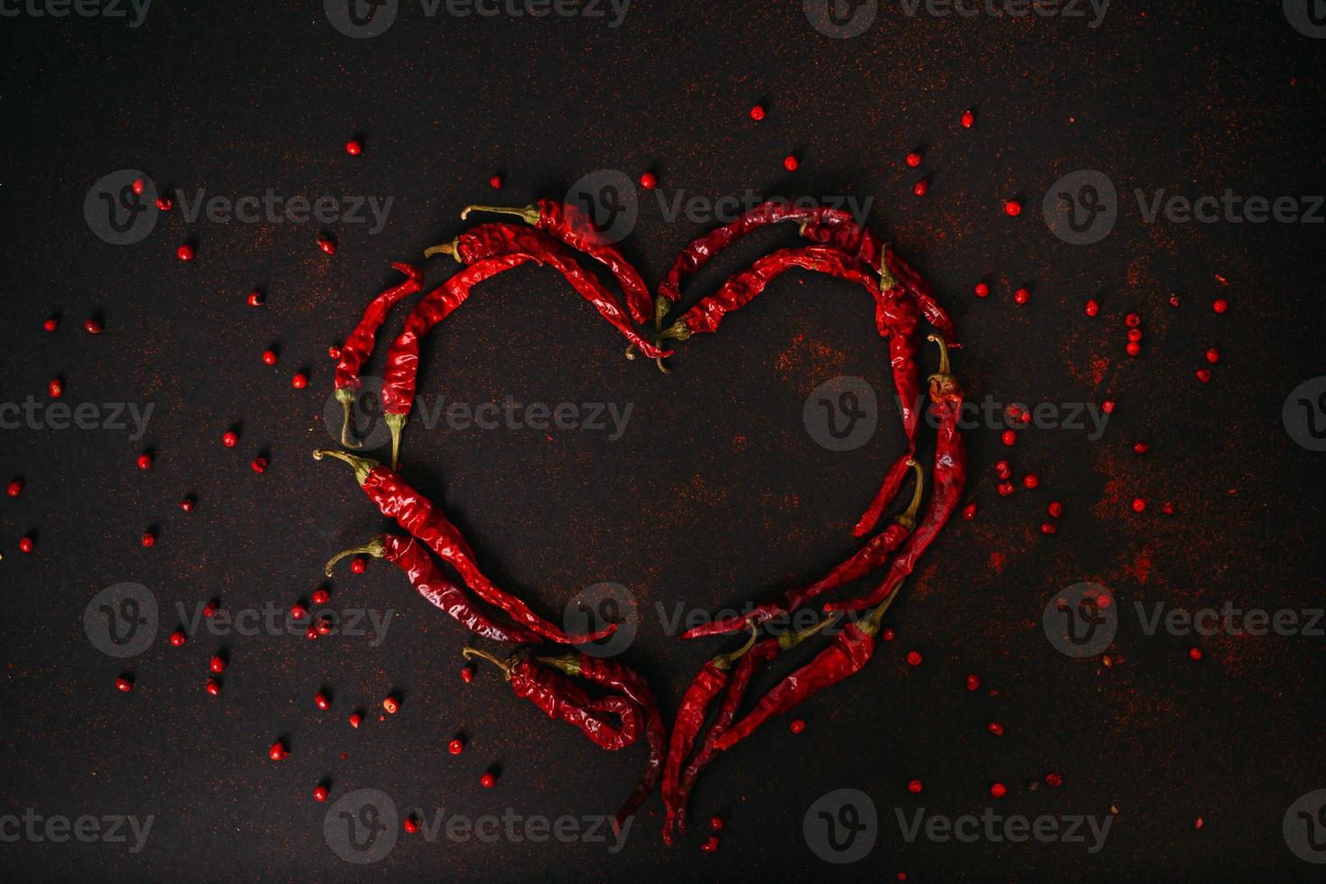 Chilli pepper heart on black photo