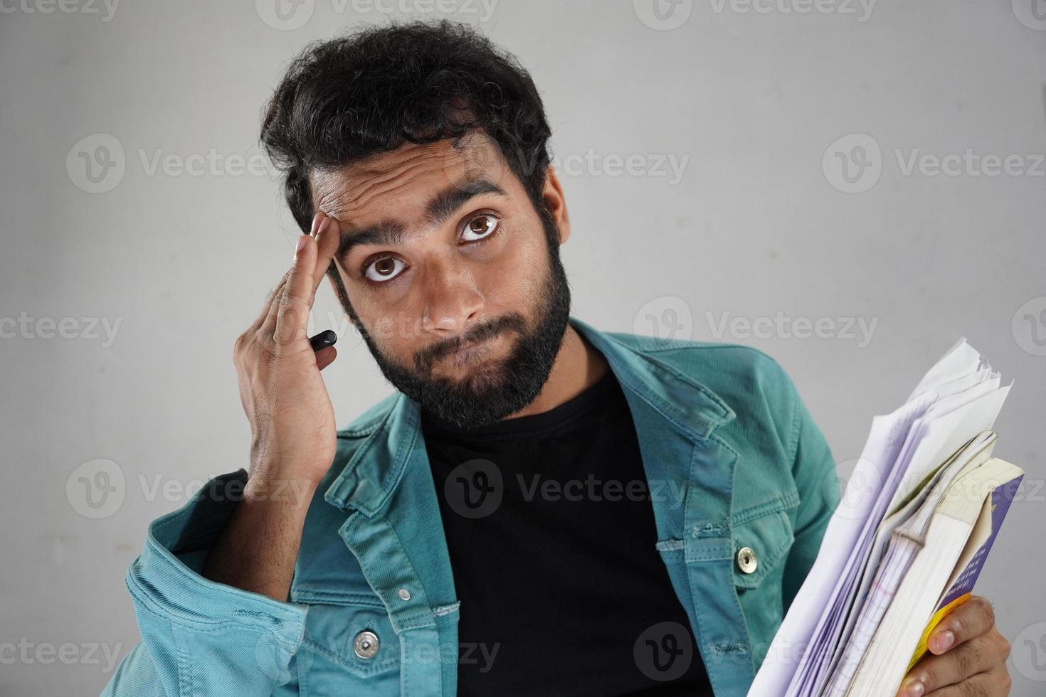 Having paper and books not intrested in stuy with white background photo