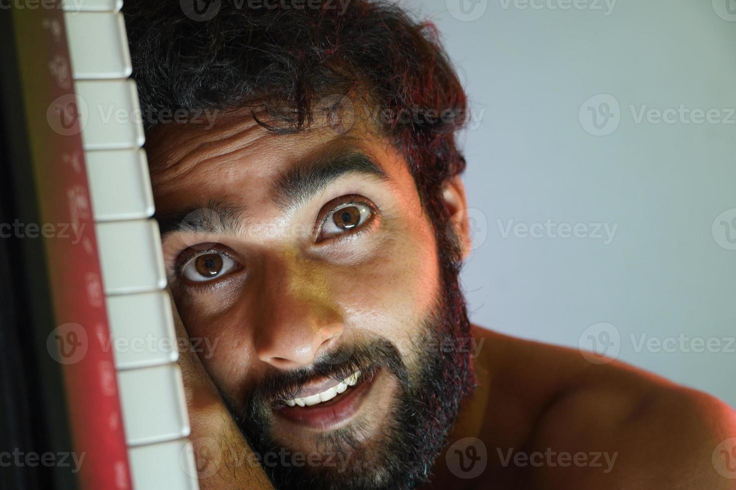 happy face man with electronic piano photo