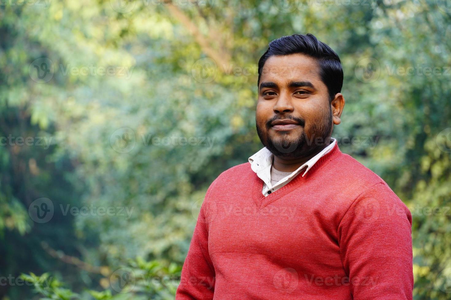 Young man giving a smile standing at park at morning work photo