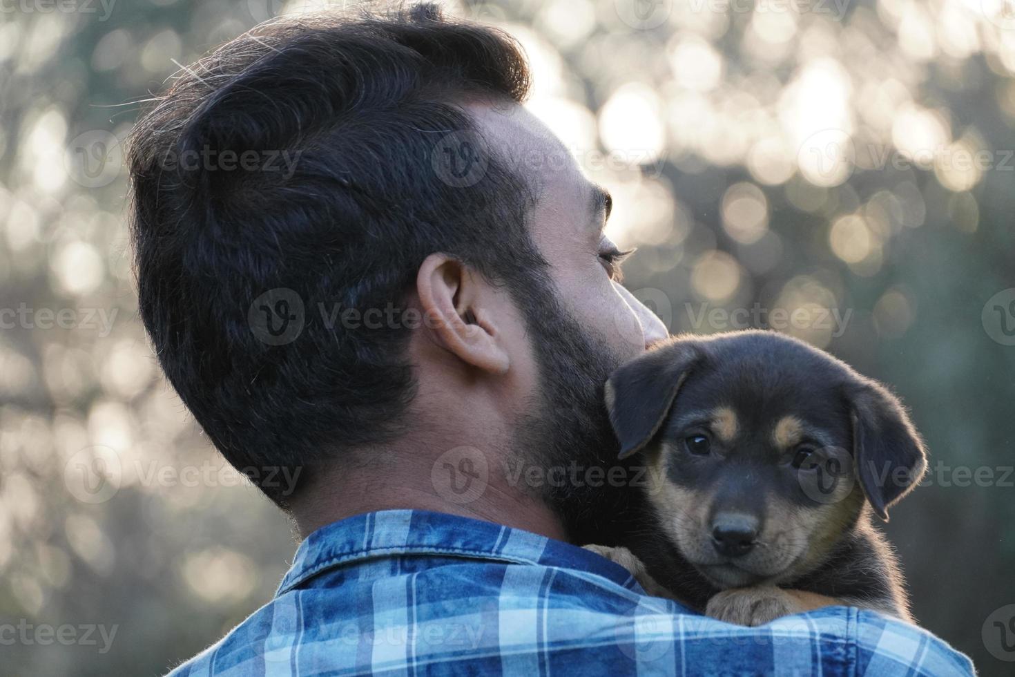 young boy with a cute puppy in park photo