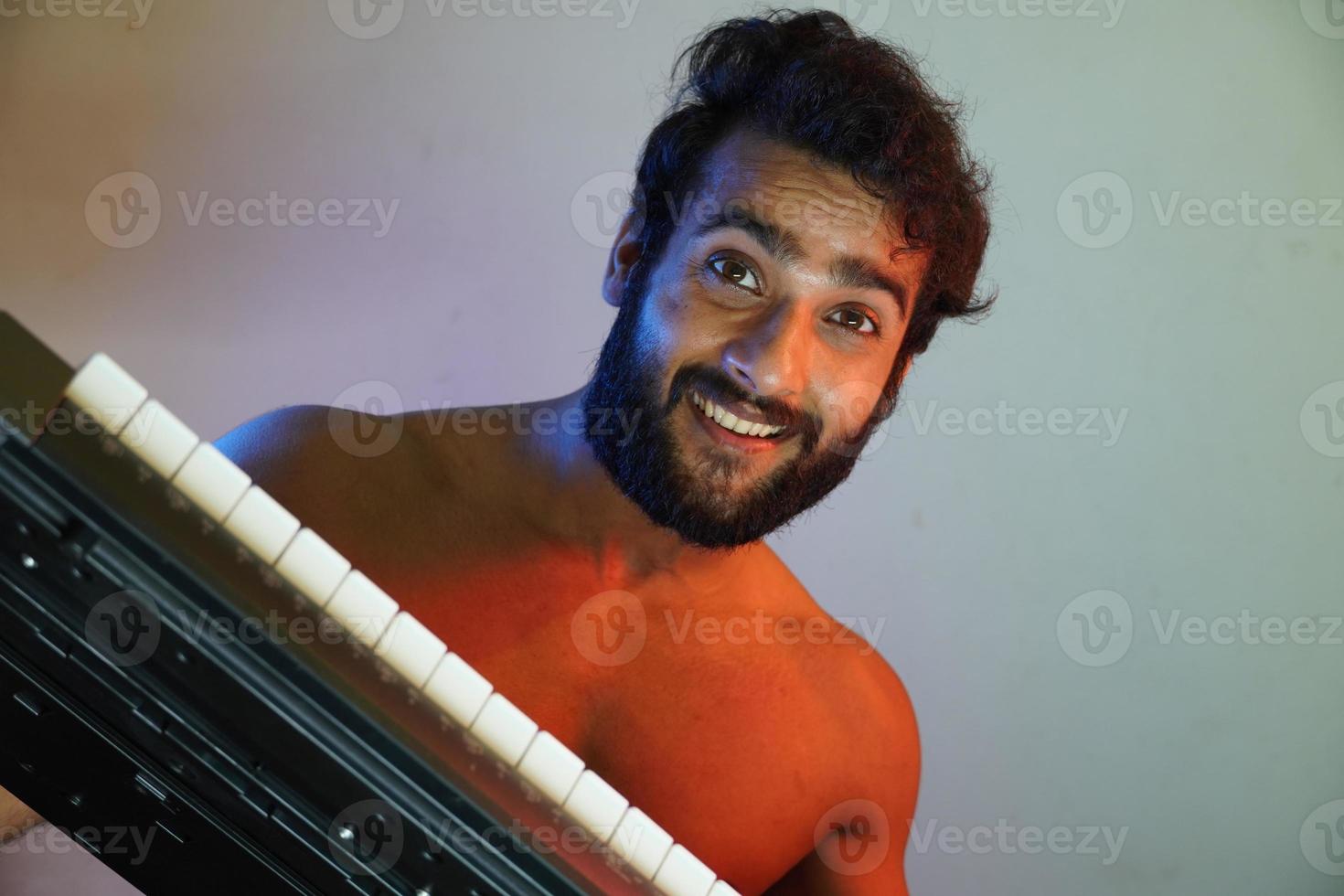 happy face man with electronic piano photo