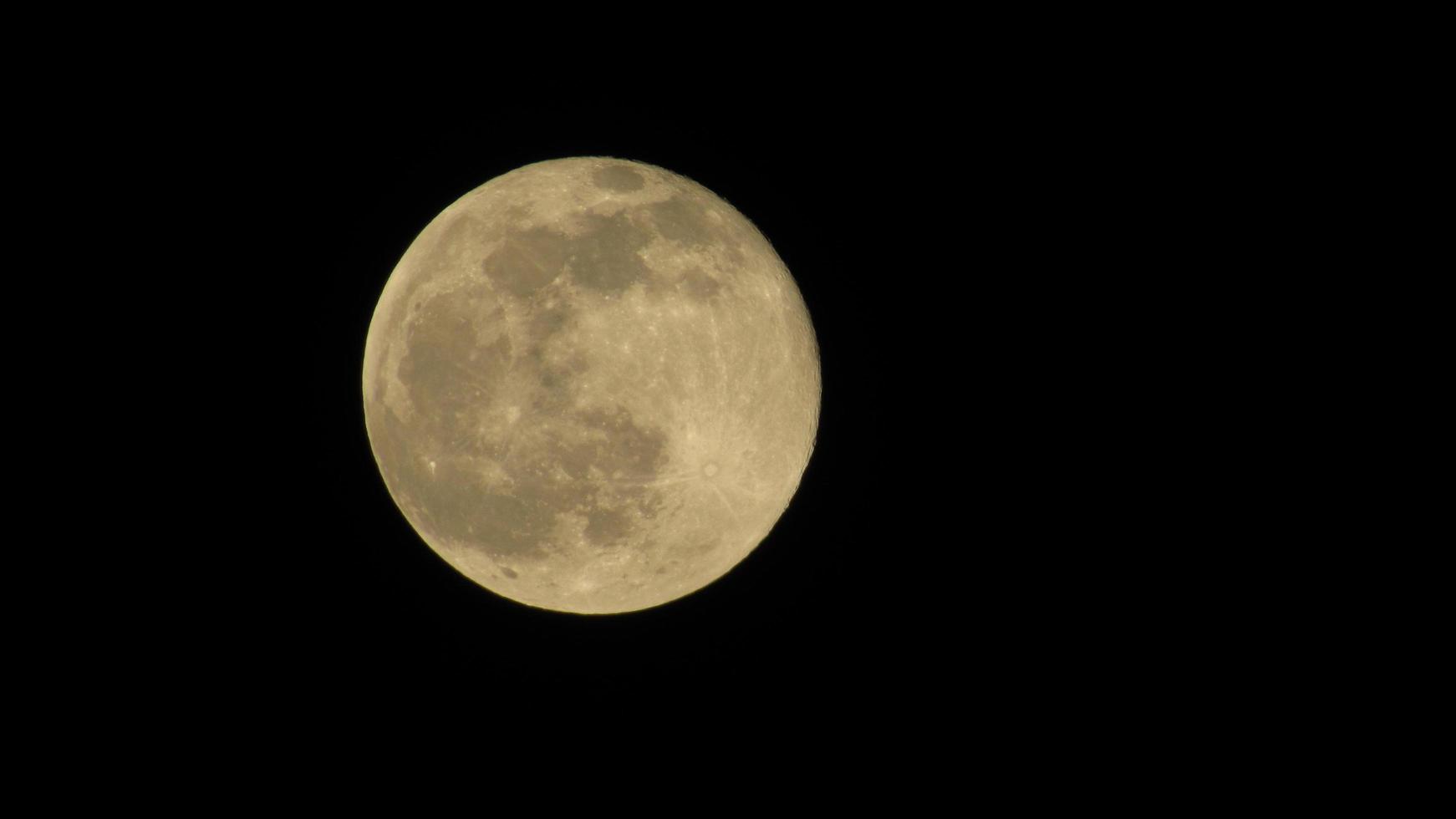 Full moon in the night sky. Black lunar background. Wallpaper with the moon. photo