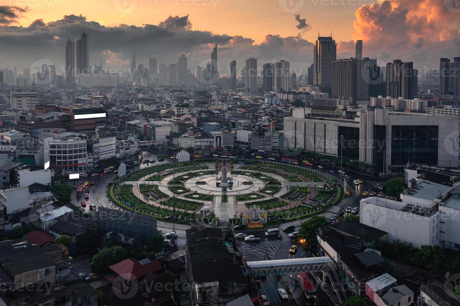 Wongwianyai roundabout monument with car traffic and skyscraper in downtown at Bangkok, Thailand photo