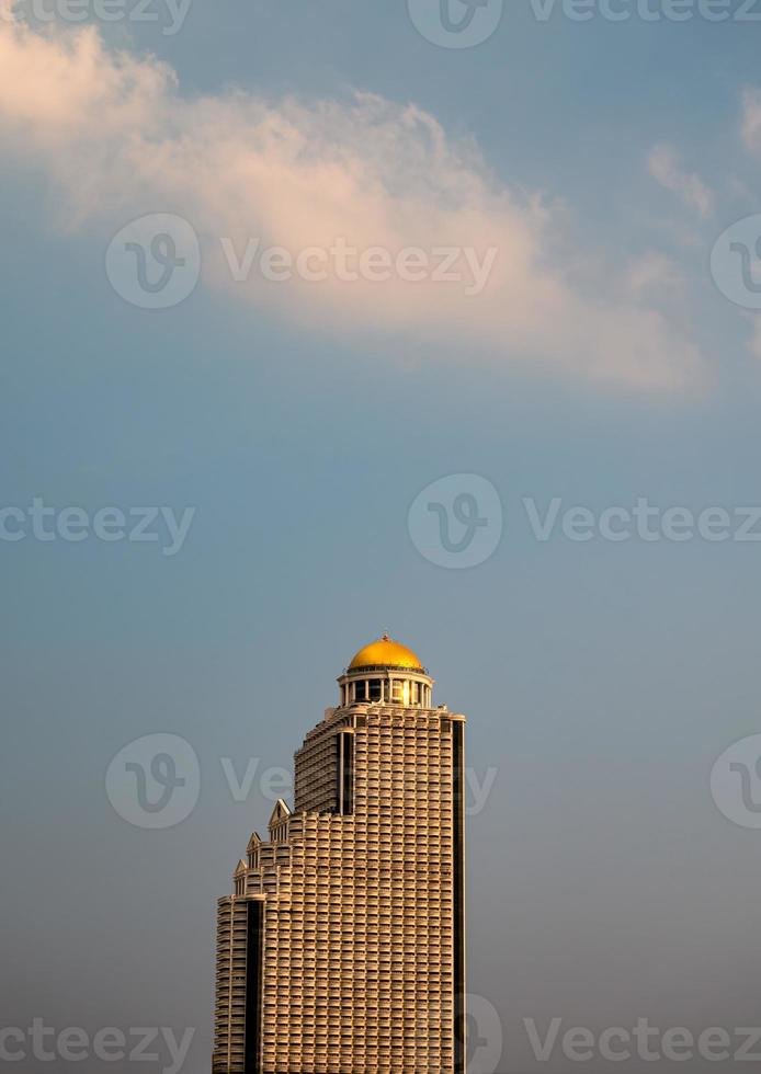 Retro golden dome high-rise condominium with many balcony layer and sunset sky in downtown photo