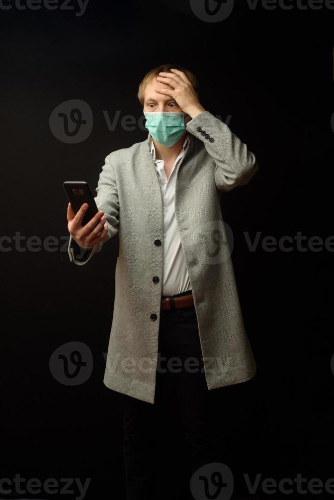 A man in a coat is talking on the phone with his doctor. photo