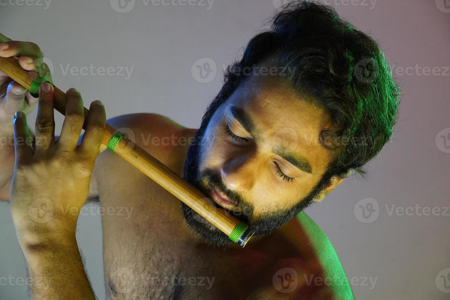 a man playing flute indian bansuri photo