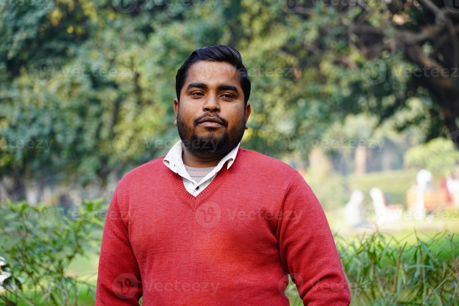 Young man giving a smile standing at park at morning work photo