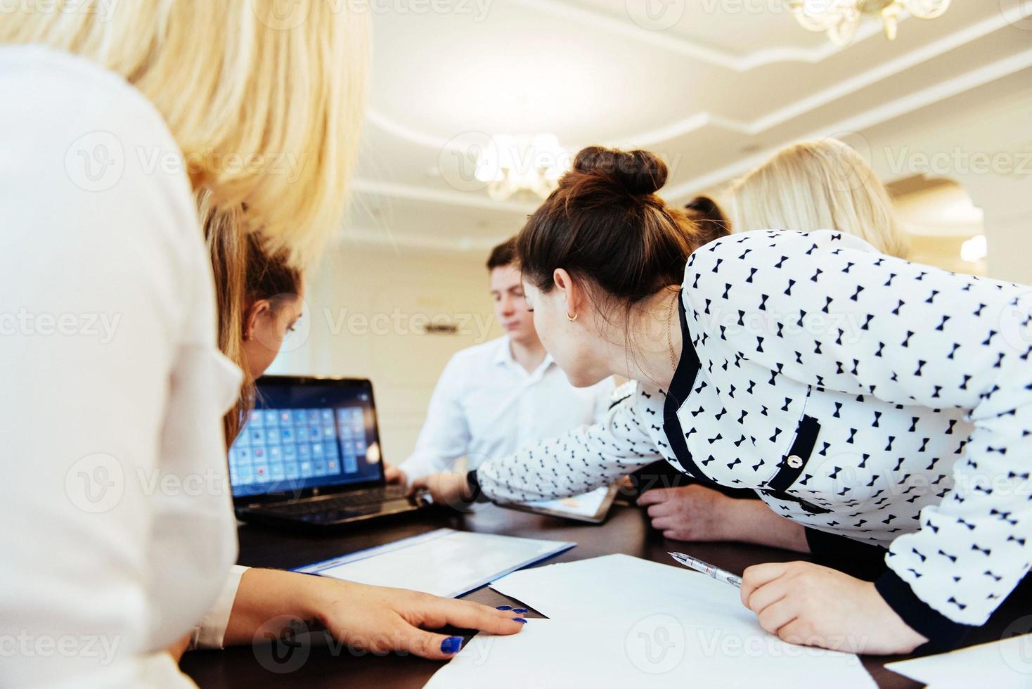 Group of students studying using a laptop photo