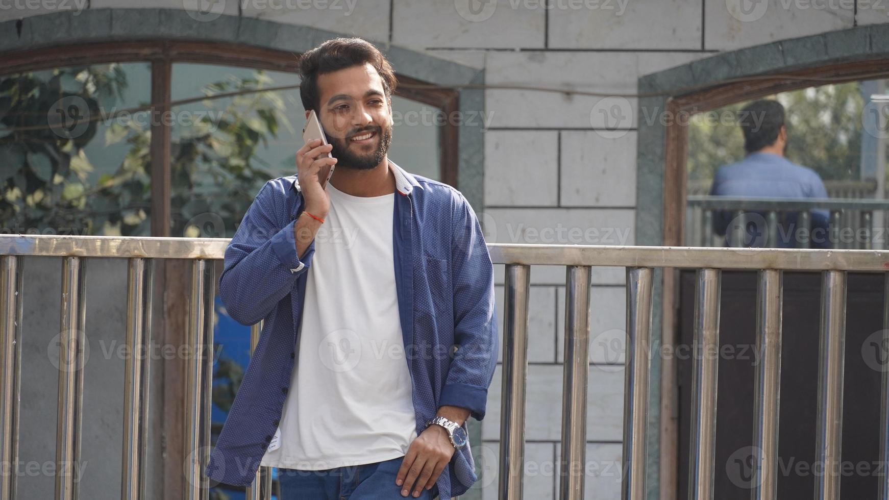 Handsome man cell phone call smile outdoor city street, Young attractive businessman casual blue shirt talking photo