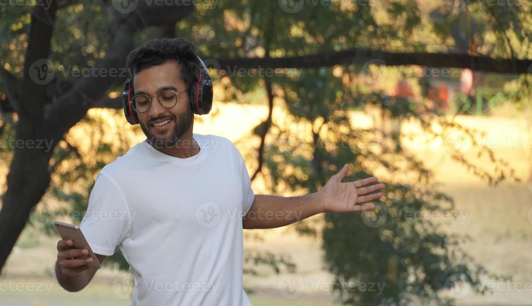 man listening to music and dancing alone photo