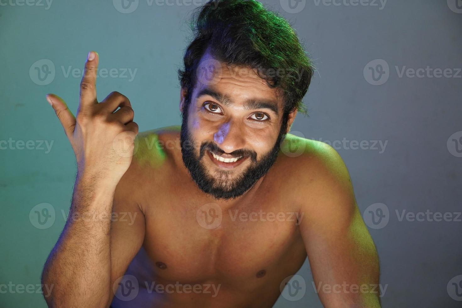 young man smiling face without cloths studio shot photo