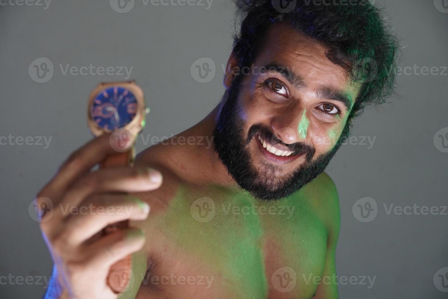 man showing his watch and smiling photo