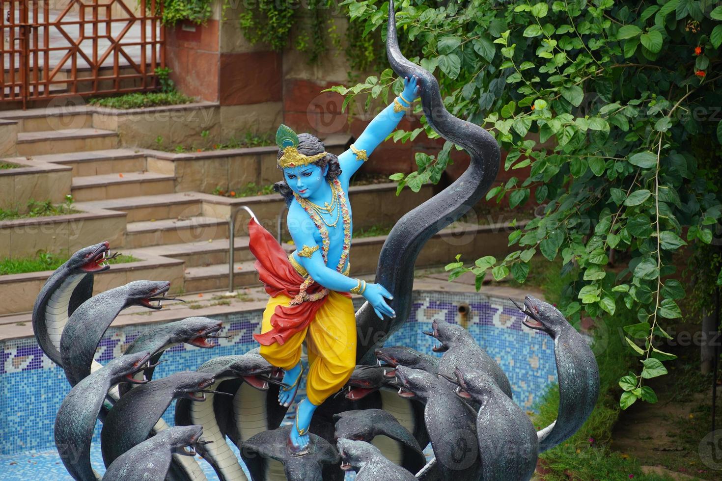 Shree Krishna with Kalia snake Indian Hindu God image photo