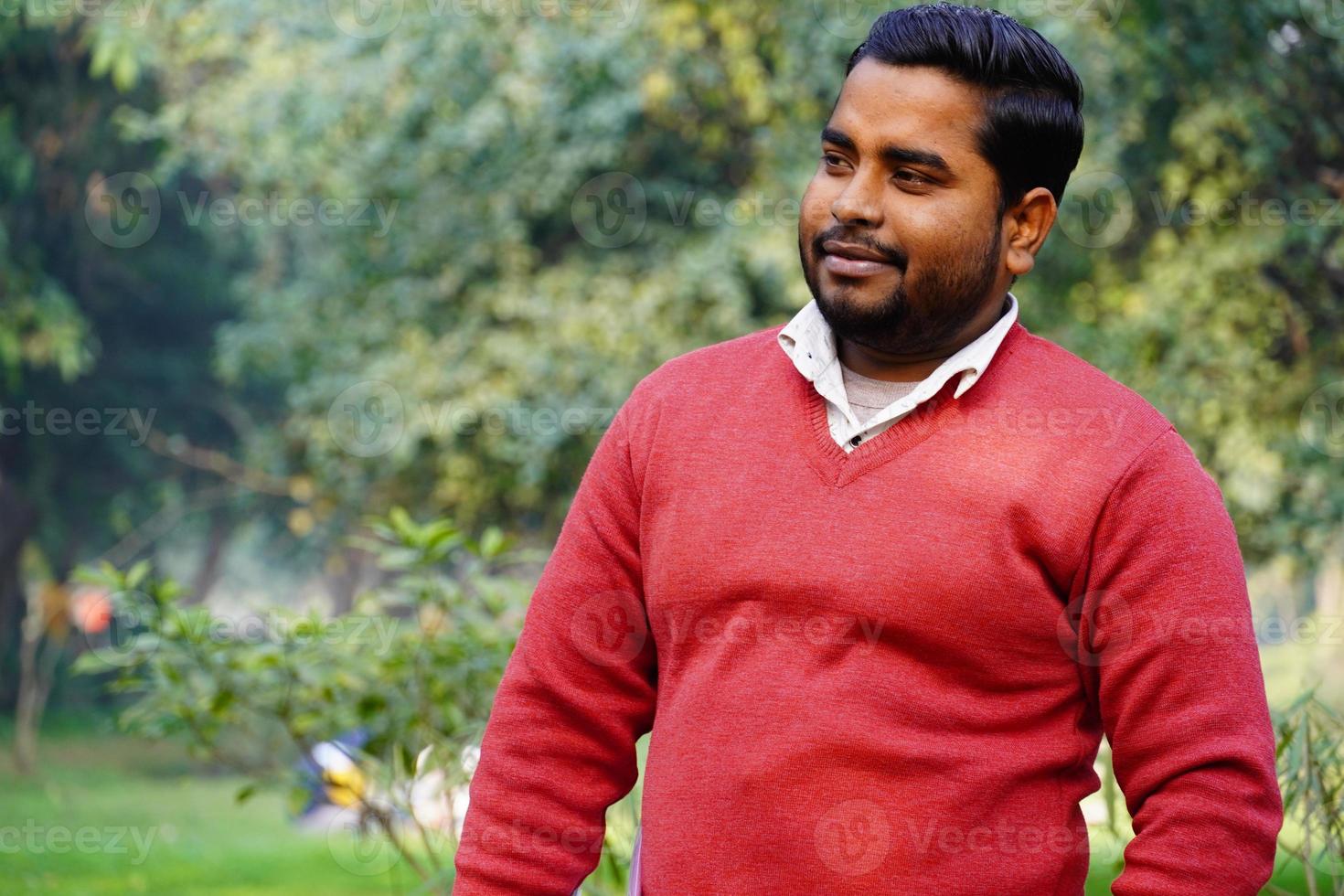 Young man giving a smile standing at park at morning work photo