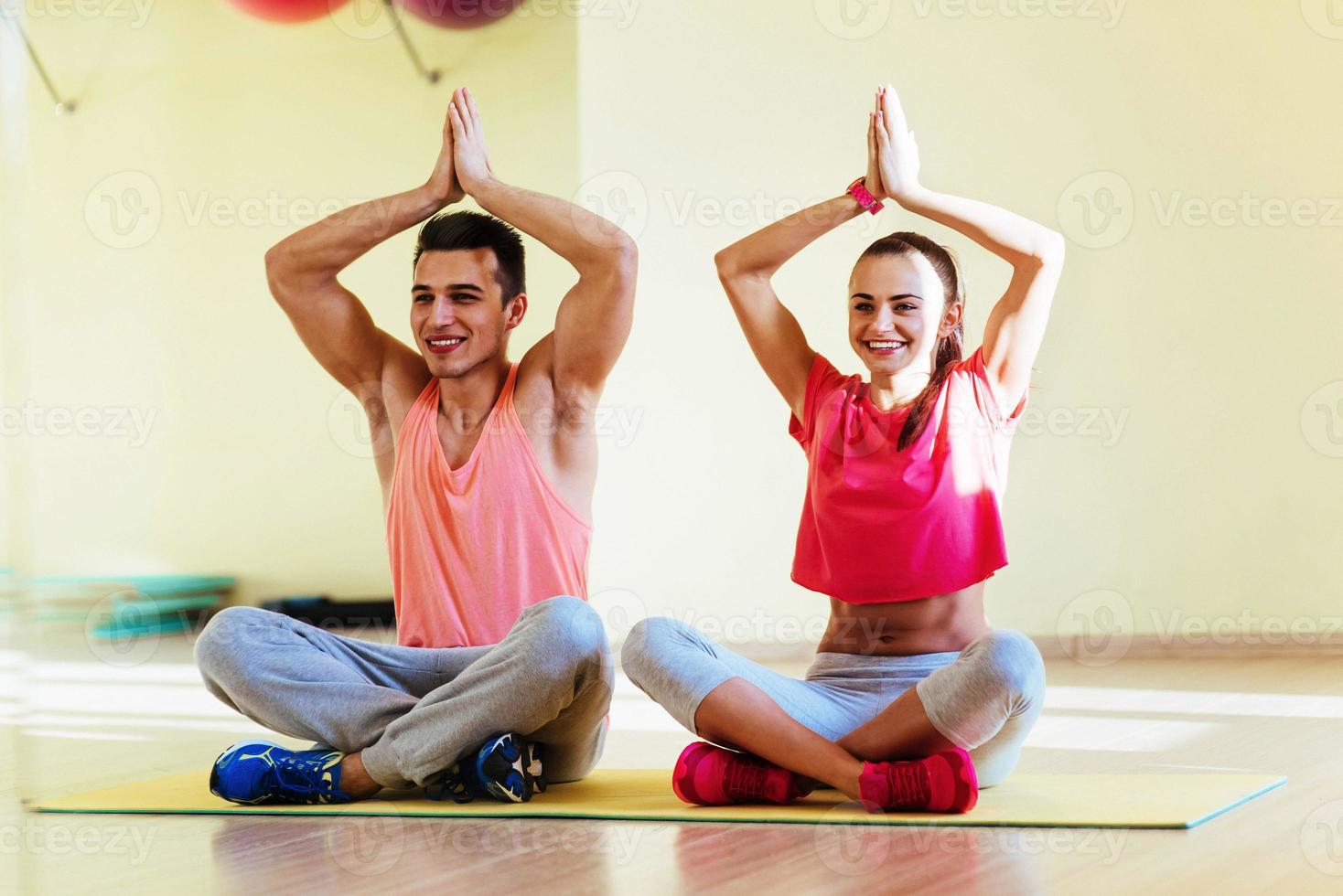 Young man and woman doing yoga. Lotus pose meditation photo