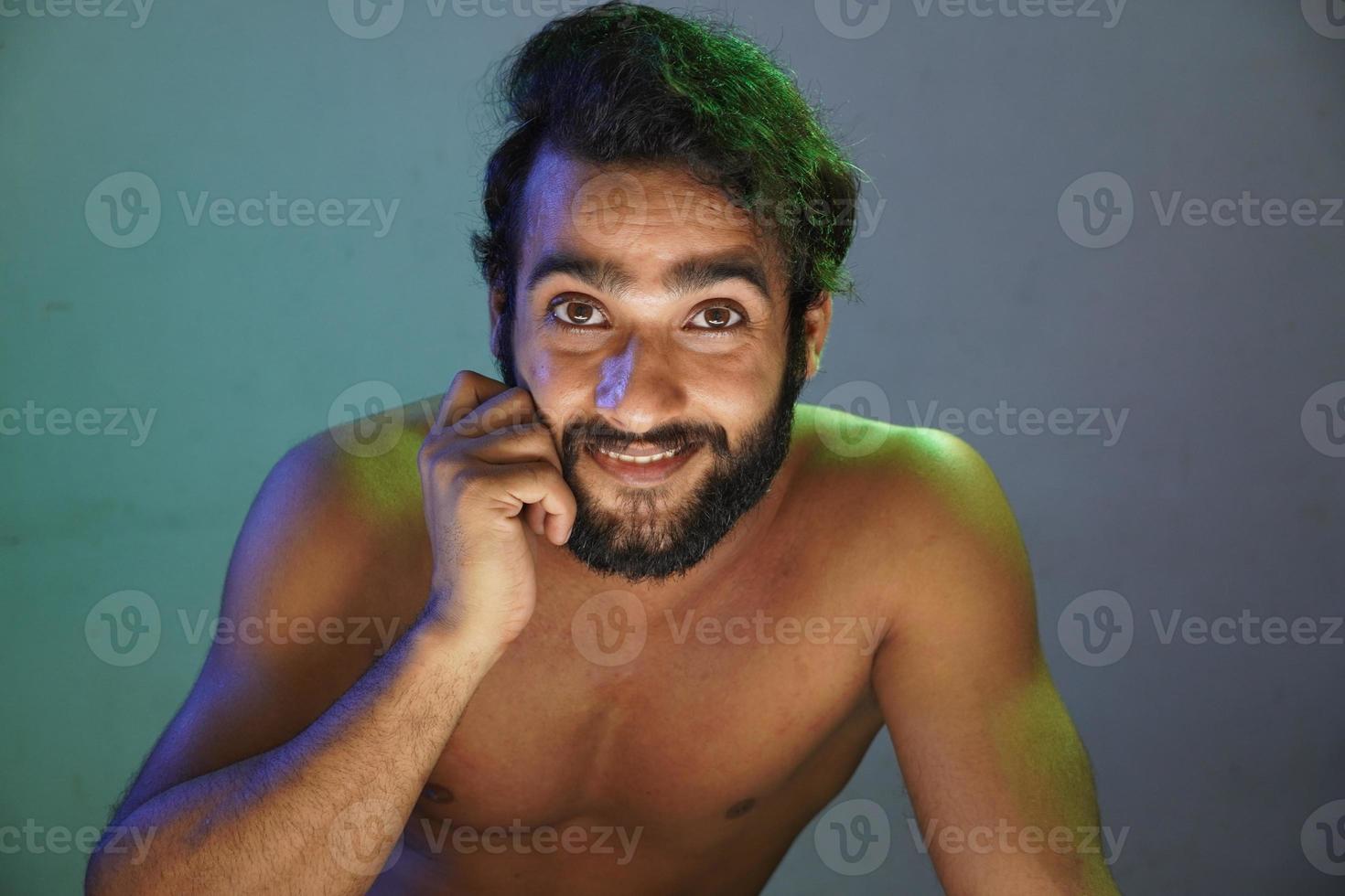 young man smiling face without cloths studio shot photo