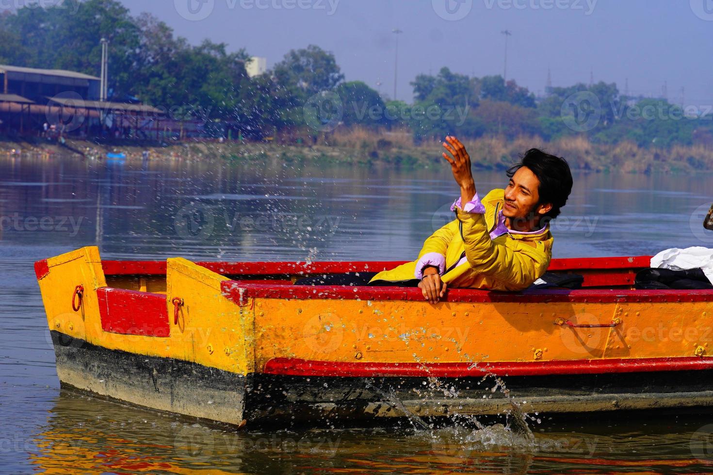 el hombre disfruta con agua sentado en el bote foto