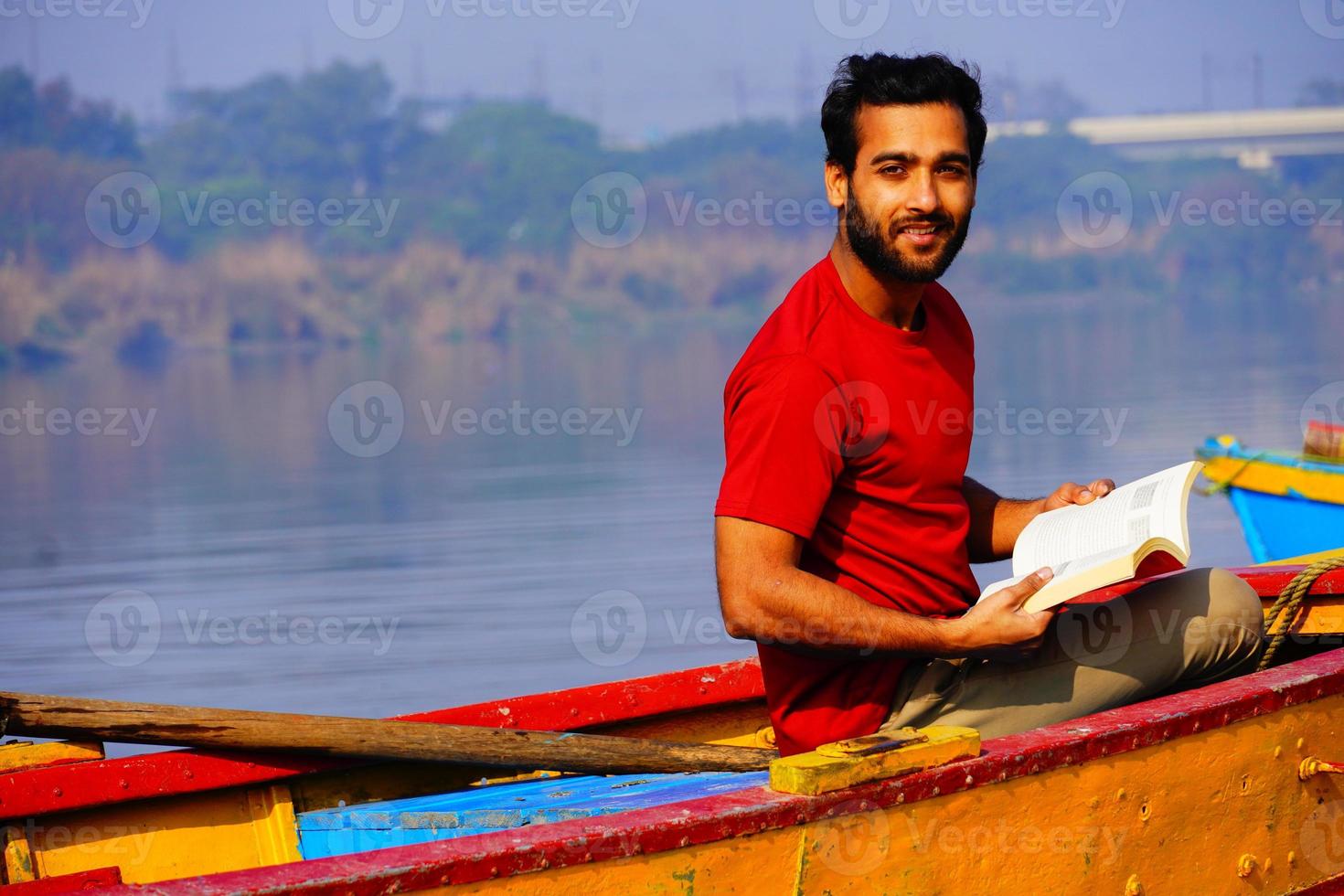 Young man reading a book photo