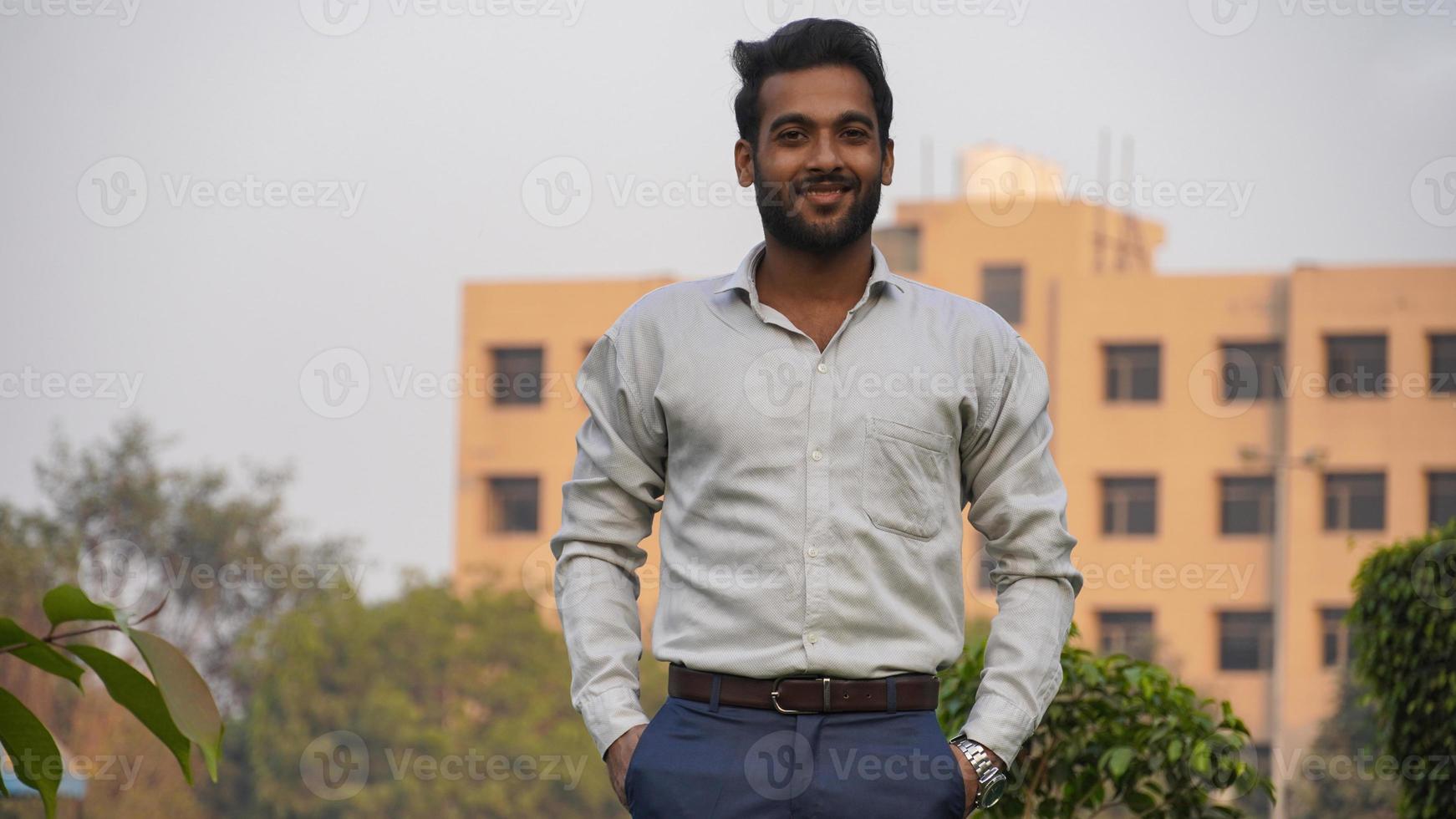 young teacher Standing outside of Collage - Happy Smiling Young Teacher photo