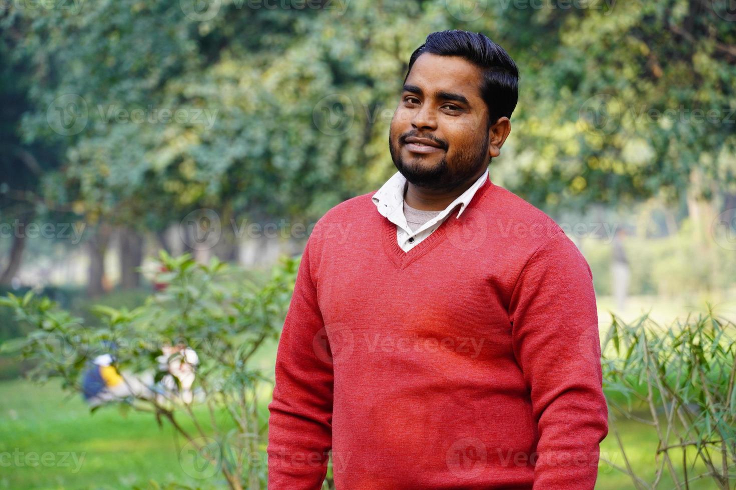 Young man giving a smile standing at park at morning work photo