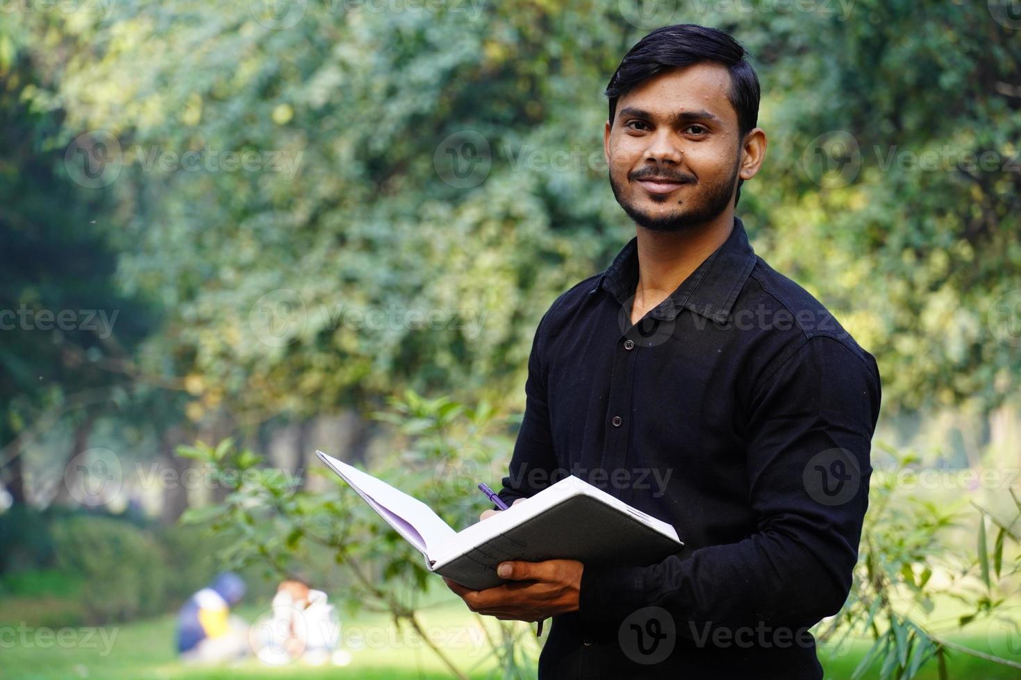 Young college student watching camera and giving a smile photo
