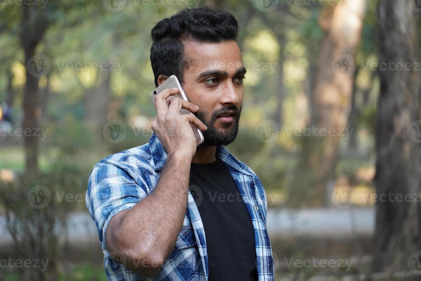 young man indian student talking on call portrait photo